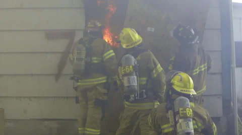Fire fighters look at fire inside house Stock Footage 60753347
