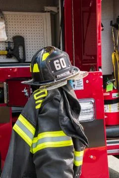Fire fighting gear including helmets and jackets were displayed near a fire t Stock Photos