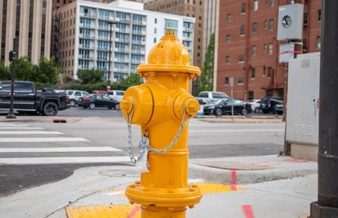 Fire fighting public system. Fire hydrant yellow color painted outdoors in th Stock Photos