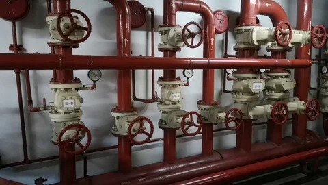 Fire fighting valve in pump room building system with red colour pipes. Stock Footage 98161492