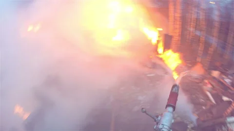 Fire. Firefighter extinguishes fire from the trunk Stock Footage 55610644