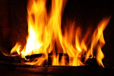 Fire in a fireplace, fire flames on a black background Stock Photos