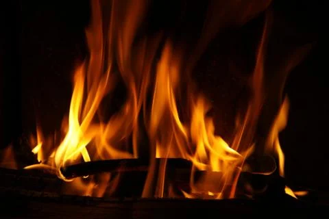 Fire in a fireplace, fire flames on a black background Stock Photos