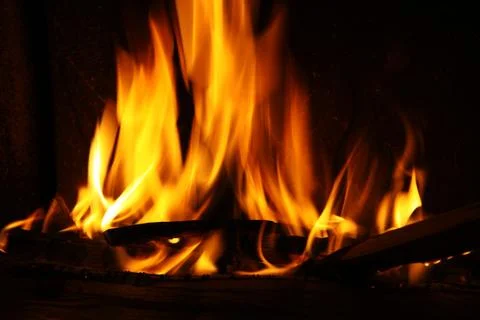 Fire in a fireplace, fire flames on a black background Stock Photos