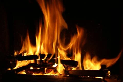 Fire in a fireplace, fire flames on a black background Stock Photos