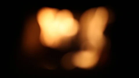 The fire in the fireplace flame at black background. Out of focus is blurry.  Stock Footage 106660555