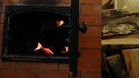 Fire in a fireplace with an open door in the house Stock Footage 168768121
