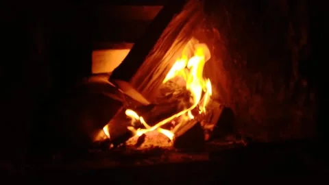 A fire in a fireplace shot from the left side Stock Footage 168768092