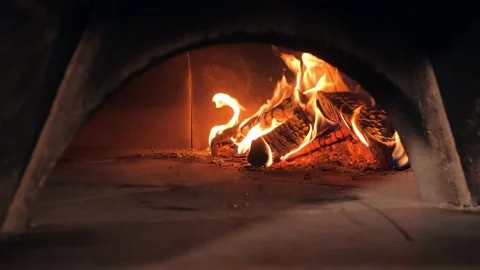 Fire flame covers chopped firewood pile heating oven Video stock 132473943