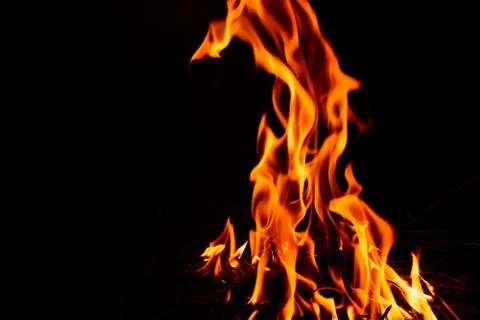 Fire flame on dark background. Stock Photos