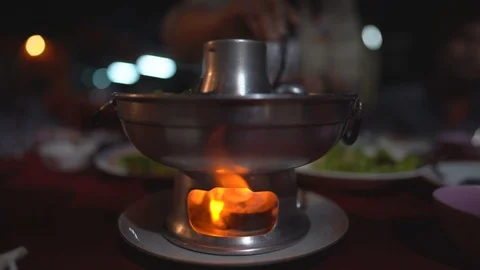 Fire flame glowing to hot of soup pot on table and blurred background Stock Footage 124427455