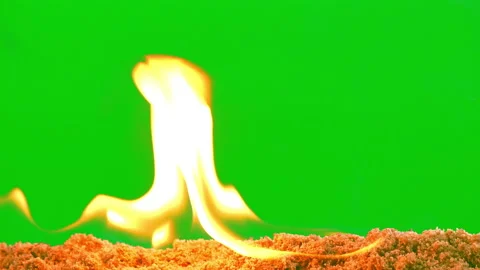 Fire flame glowing slow motion on sand of green screen background Video stock 239554621