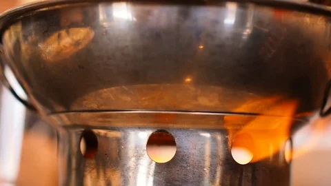 Fire flame heating hot pot stainless steel bowl, close up Stock Footage 80724127