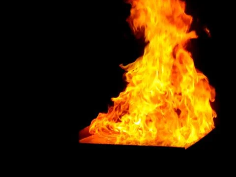 Fire flame isolated on black Stock Photos