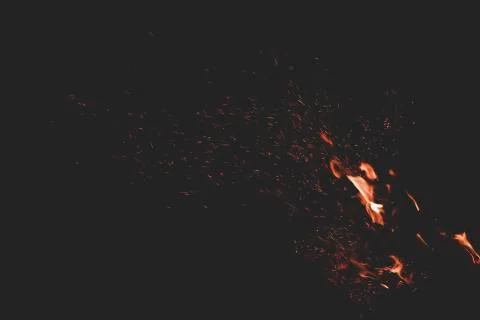 Fire flame orange sparkles motion in dark wallpaper pattern background space  Stock Photos