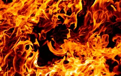 Fire flame texture. Fire sparks. Fire on black background. Fire glowing effect. Stock Photos