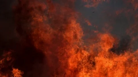 Fire flames and ashes against blue sky in  slowmotion 스톡 동영상 75153290