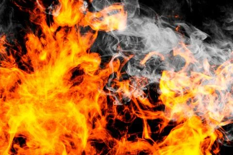Fire flames background. Cloud of  fiery smoke on a black isolated background. Stock Photos