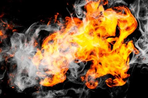 Fire flames background. Cloud of  fiery smoke on a black isolated background. Stock Photos
