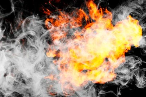 Fire flames background. Cloud of  fiery smoke on a black isolated background. Stock Photos