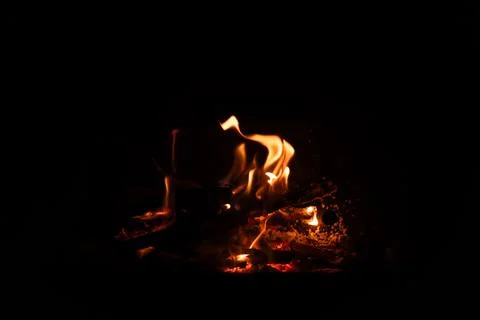 Fire flames on black background. Blazing campfire isolated on dark background Stock Photos