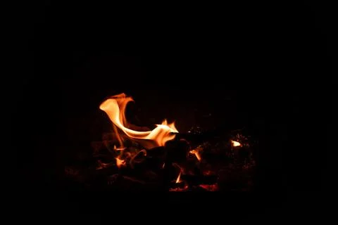 Fire flames on black background. Blazing campfire isolated on dark background Stock Photos
