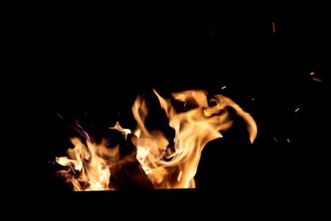 Fire flames on a black background. The fire burns on a black background. Stock Photos