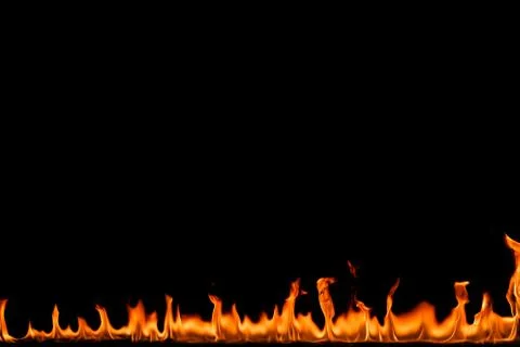 Fire flames on black background. Stock Photos