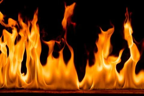 Fire flames on black background. Stock Photos