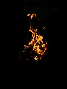 Fire flames on black background, vertical photo Stock Photos