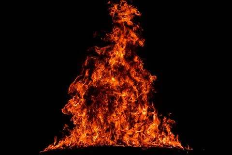Fire flames burn on black background. Fire texture rises above heat. Black .. Stock Photos