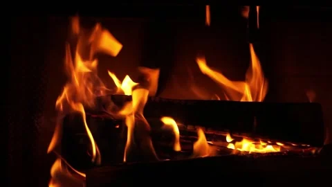 Fire flames burning brightly in a dark fireplace Stock Footage 324110673
