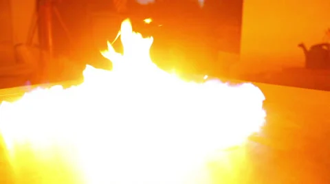 Fire flashes and spreads on reflective surface Stock-Footage 38121545