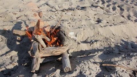 Fire in the form of a well burning on sand Stock Footage 80939576