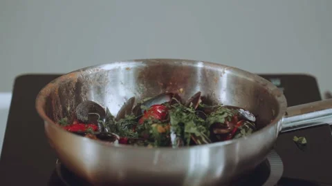 Fire in a frying pan, setting fire to a frying pan, setting fire to seafood Stock Footage 233888586