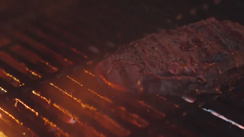 Fire Glow from BBQ Light Juicy Rare Sirloin Steak as it's Flipped by Chef. Stock Footage 343898799