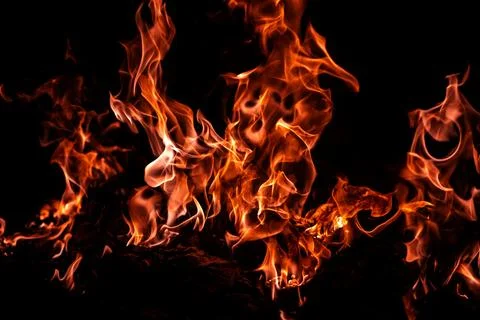 Fire glows through darkness. Fire creates burning flame. Fire forms fiery t.. Stock Photos