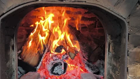 The fire glows warmly inside the brick oven, ready for fresh pizza. Stock Footage 320869287