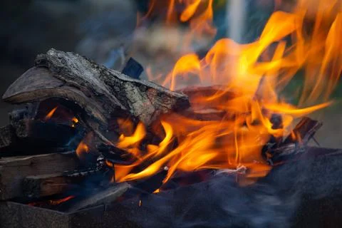 A fire in the grill in a private yard, a flame of fire Stock Photos