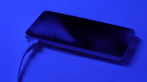 Fire hazard from mobile phone during charging. Phone battery fire while cha.. Stock Footage 296363172