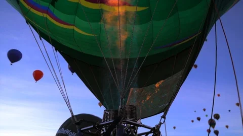 Fire heating a balloon at dawn before it ascends into the sky. Stock Footage 108740242