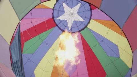 Fire heats up the inside of a hot air balloon as it prepares to begin flight Stock Footage 202045101