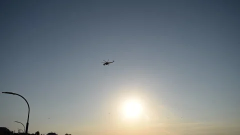 Fire helicopter against the sunset on its way to put out the fire. Stock Footage 315844079
