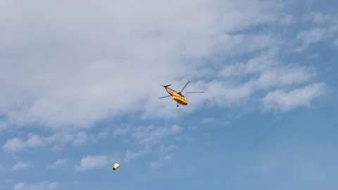 Fire Helicopter with Bucket of Water Stock Footage 134097701