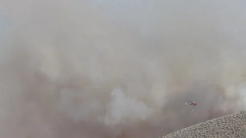 Fire Helicopter Dropping Water on Fire Stock Footage 136156310