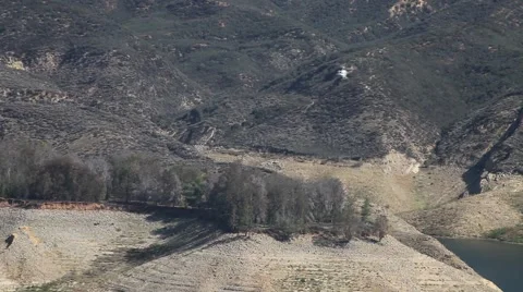 Fire helicopter fly-by over rugged lake terrain Castaic Warm Fire V18949 Stock Footage 53459812