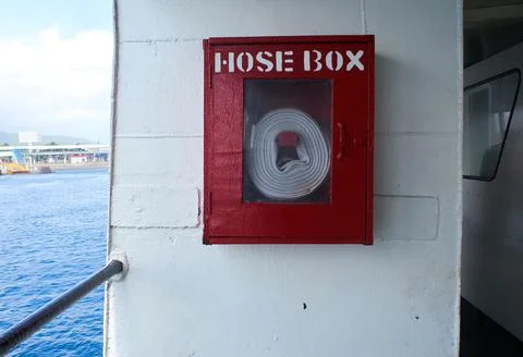 Fire hose stored in a red box on a ferry Stock Photos