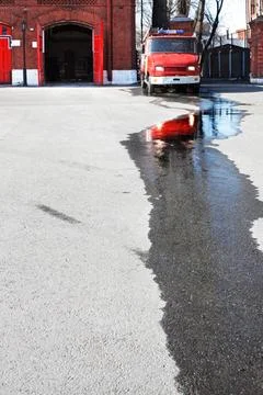 Fire house Fire engine and a puddle of the water at the firehouse Copyrigh... 库存照片