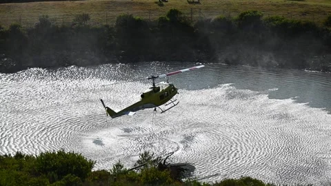 Fire Huey Helicopter getting Water for Wildfire fighting in Newlands Cape Town Stock Footage 337435796