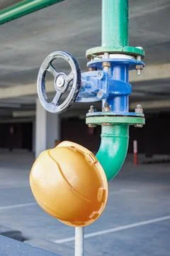 A fire hydrant and valve system are meticulously positioned within a contempo Stock-Fotos